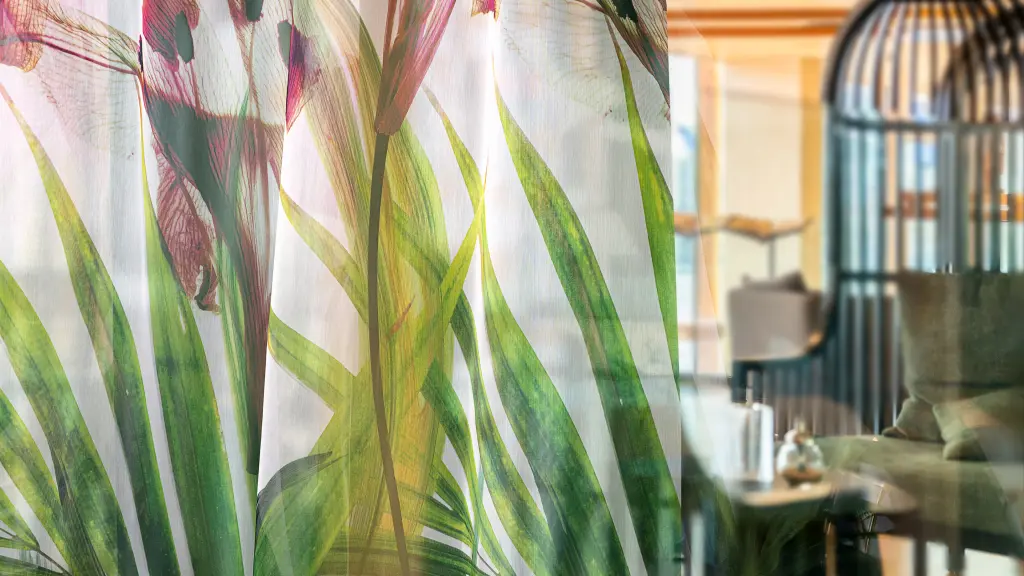 Digitally printed Vescom Chira sheer curtain, printed with a tropical floral pattern and a matte, woven look.