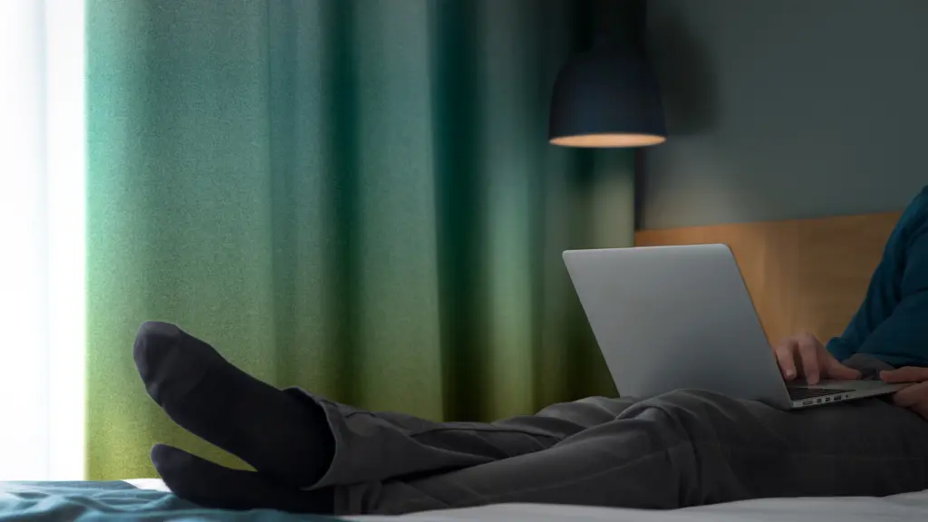 Vescom Nila matte blackout curtains with a soft green gradient in a modern hotel interior.