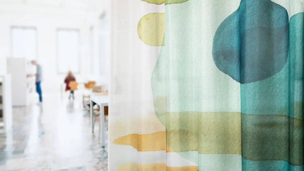 Vescom Swan sheer curtain with a matte finish and artistic watercolour print in a modern office