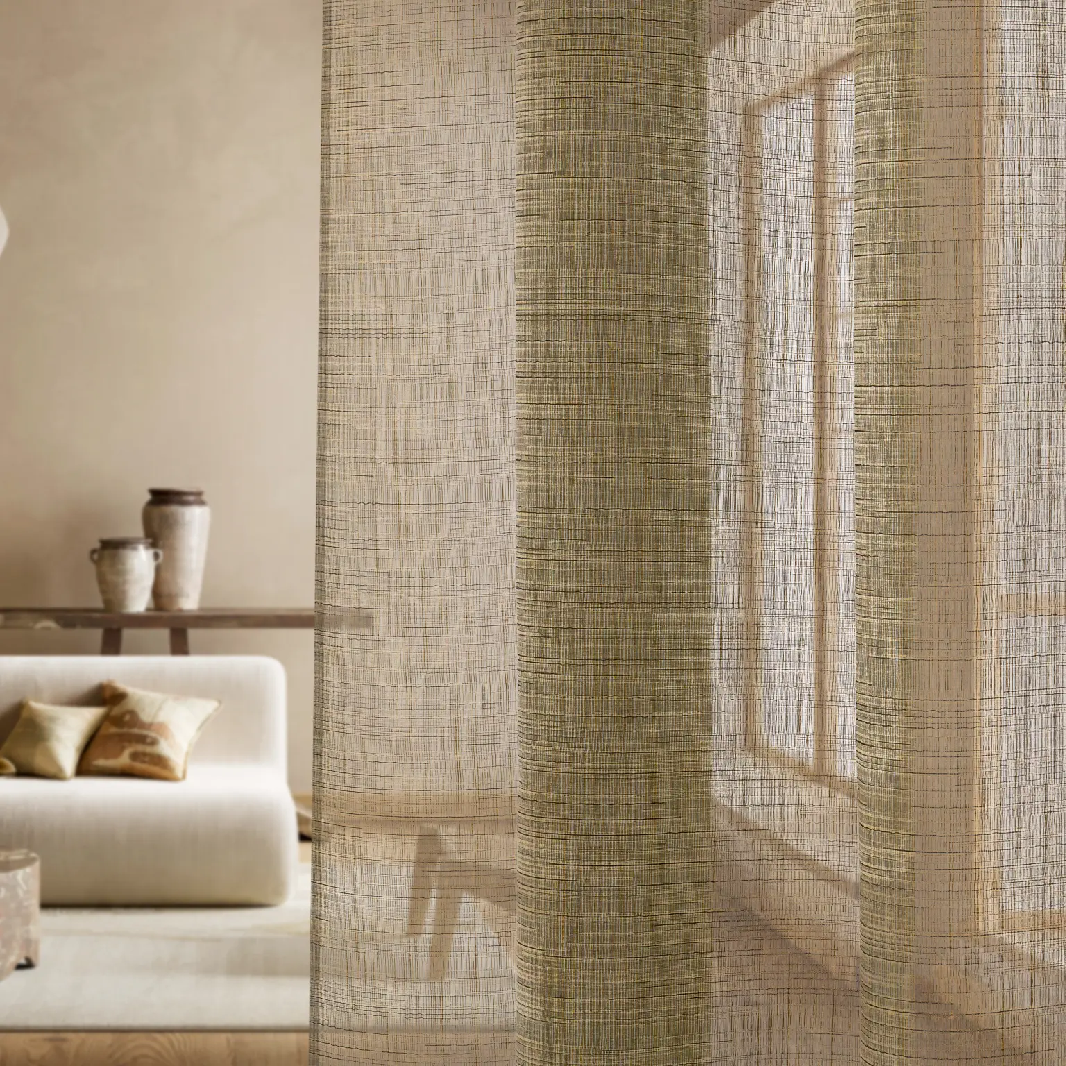 Close-up of Lindsey sheer curtain fabric in a natural beige tone, highlighting its linen-like texture, soft drape and transparency in a warm, contemporary lounge.
