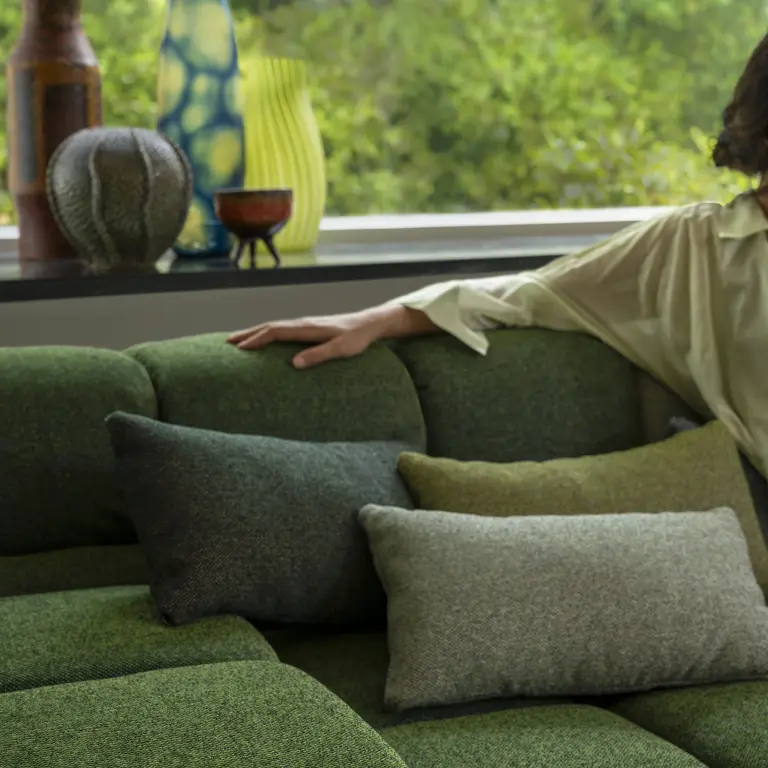 Green Vescom Bosco upholstery styled in a lush woodland setting.