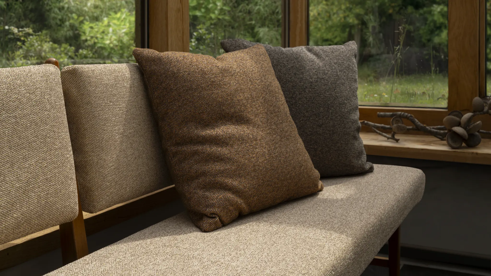 Neutral Vescom Bosco upholstery on a lounge chair surrounded by woodland textures.