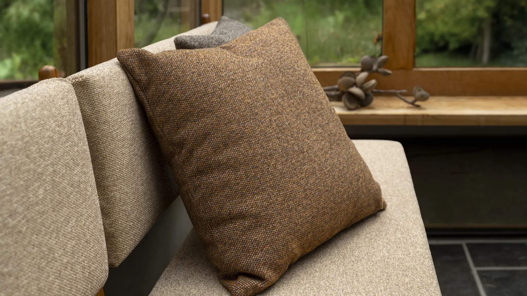 Soft neutral Vescom Bosco upholstery bringing cocooning comfort to a couch.