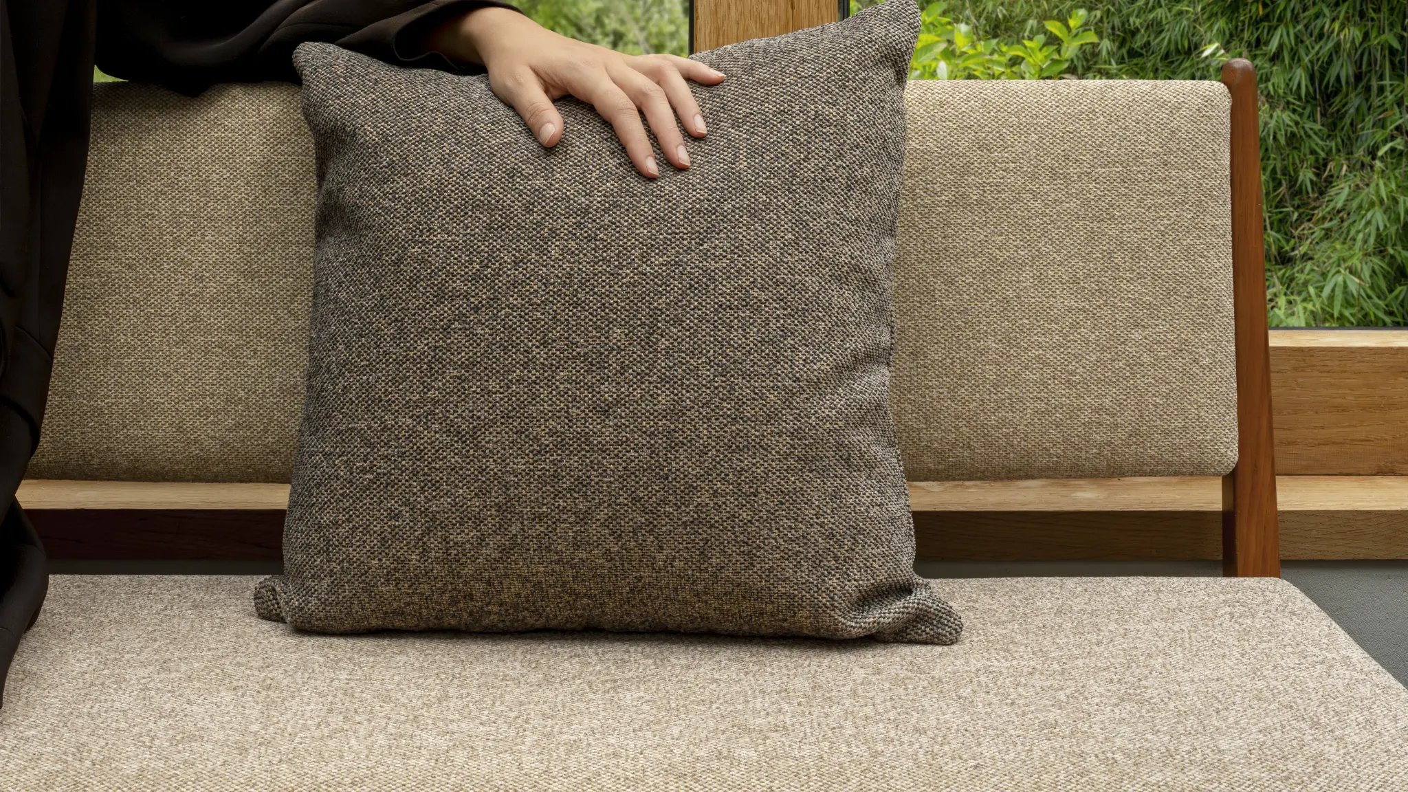 Green Vescom Bosco upholstery on a compact seat in a woodland-inspired setting.