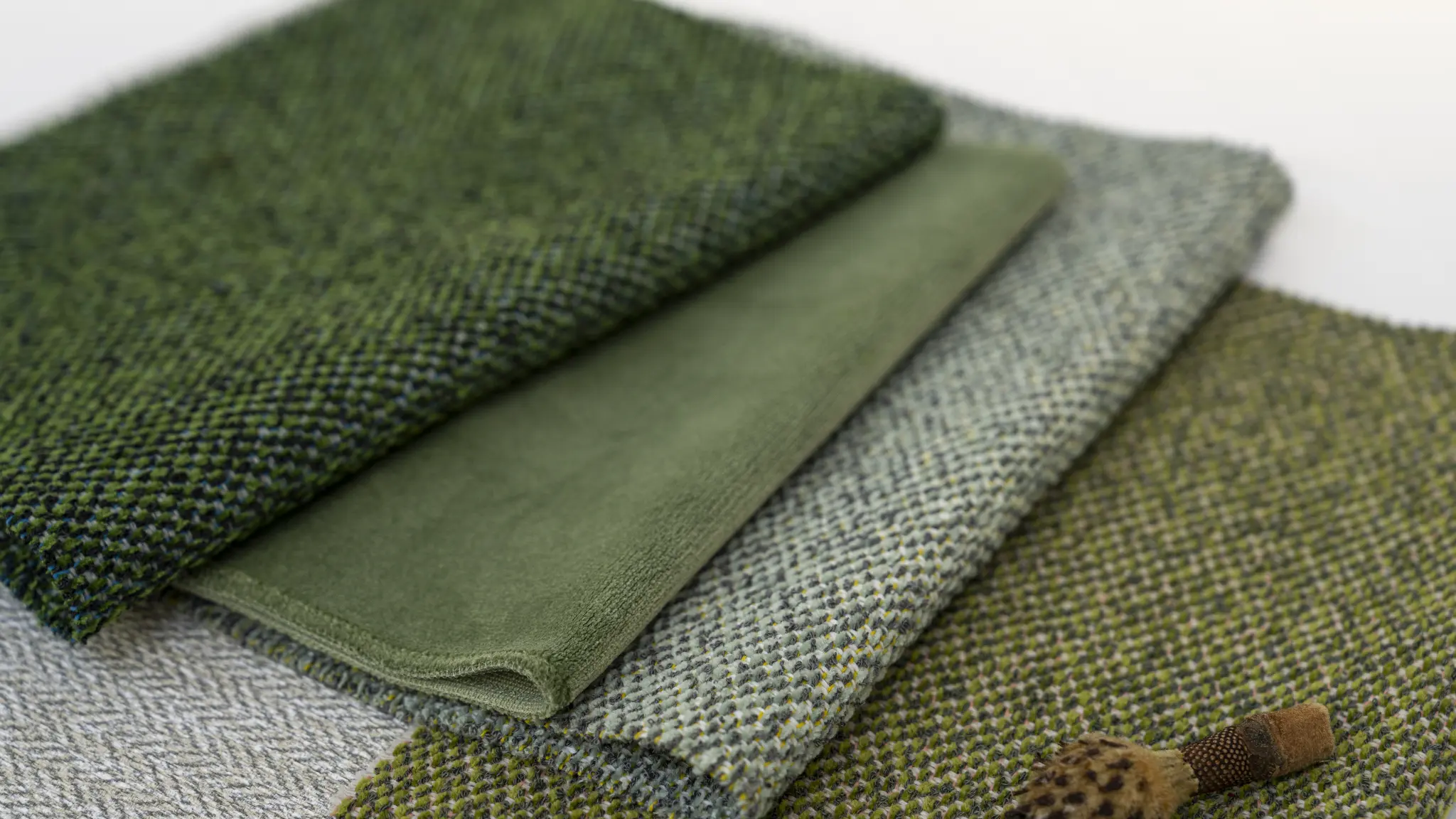 Green Vescom Bosco upholstery paired with organic forest textures.