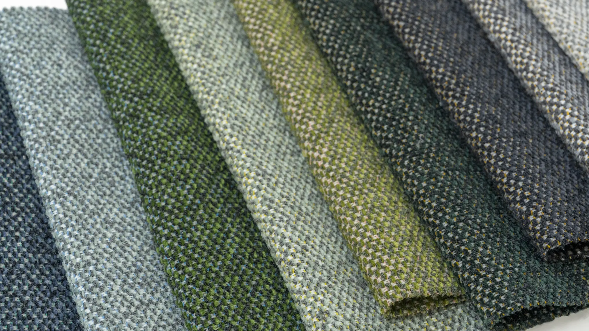 Layered green Vescom Bosco upholstery shades inspired by foliage, lichen and moss.