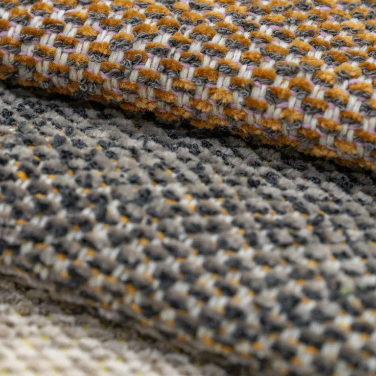 Warm ochre Vescom Bosco upholstery shades recalling bark and dried leaves.