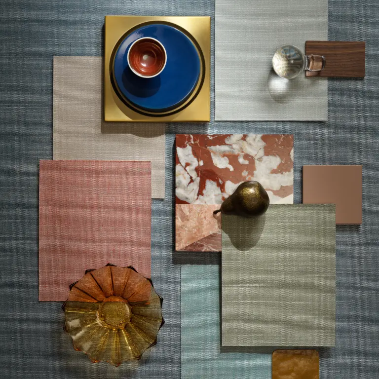 Vescom Nivelis textile wallcovering with a two-tonal woven horizontal structure and subtle melange effect, shown with layered material samples and design objects in a styled flat lay composition.