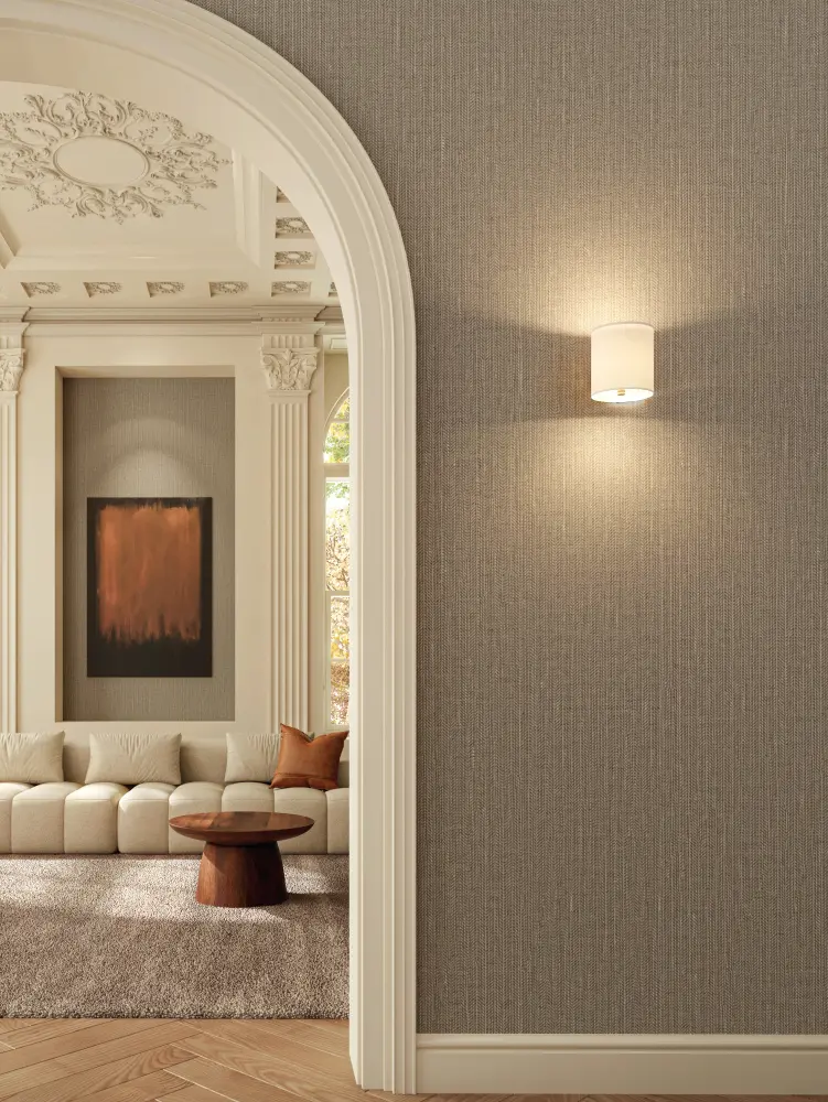 Vescom Sisu textile wallcovering featuring a structured herringbone weave that creates a measured, rhythmic surface, shown in a refined interior setting