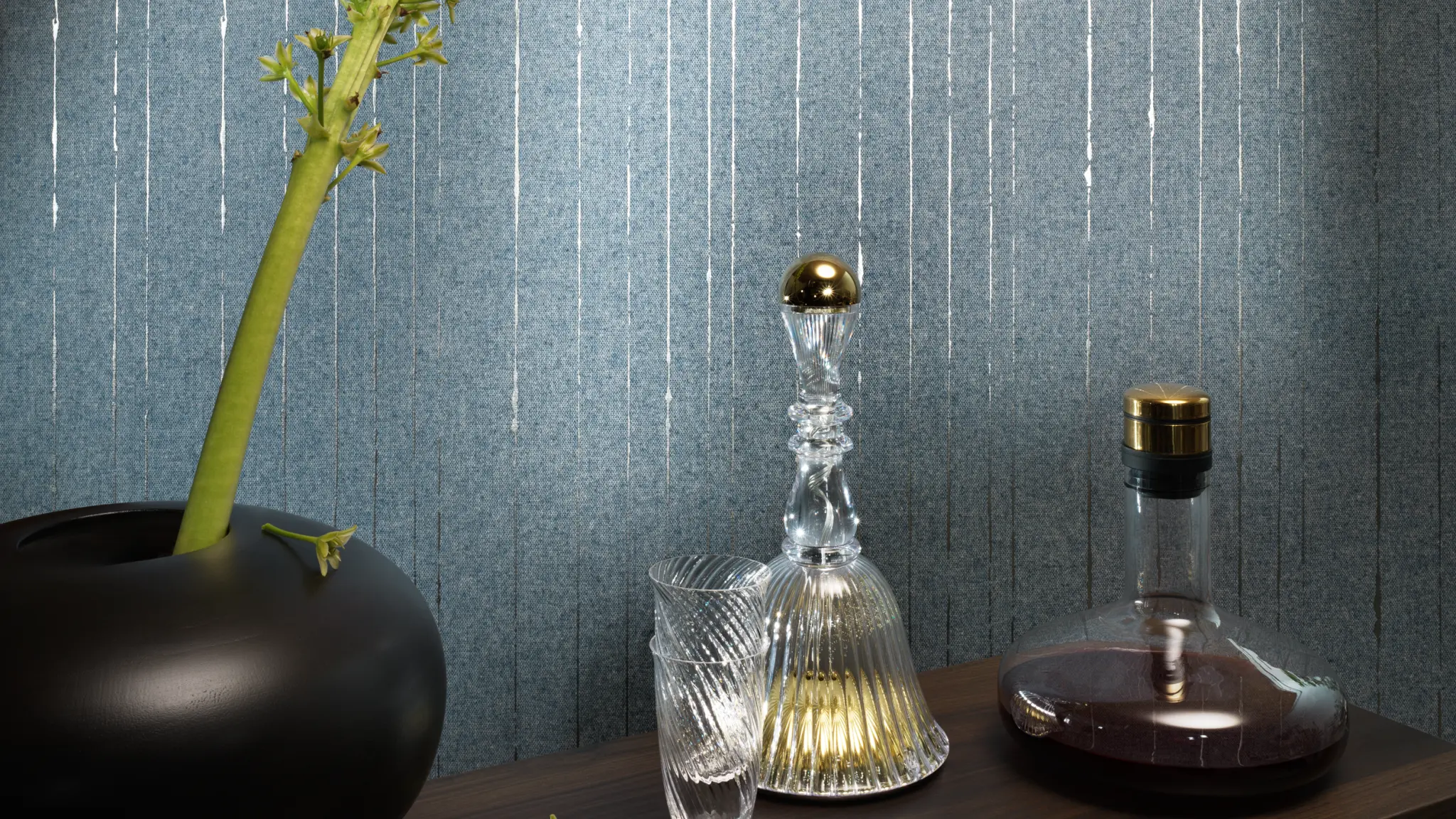 “Vescom Sofia textile wallcovering with a warm woollen weave and subtle metallic threads creating a refined shimmer, shown on interior walls behind a styled console with glass decanter, tumbler and decorative vase