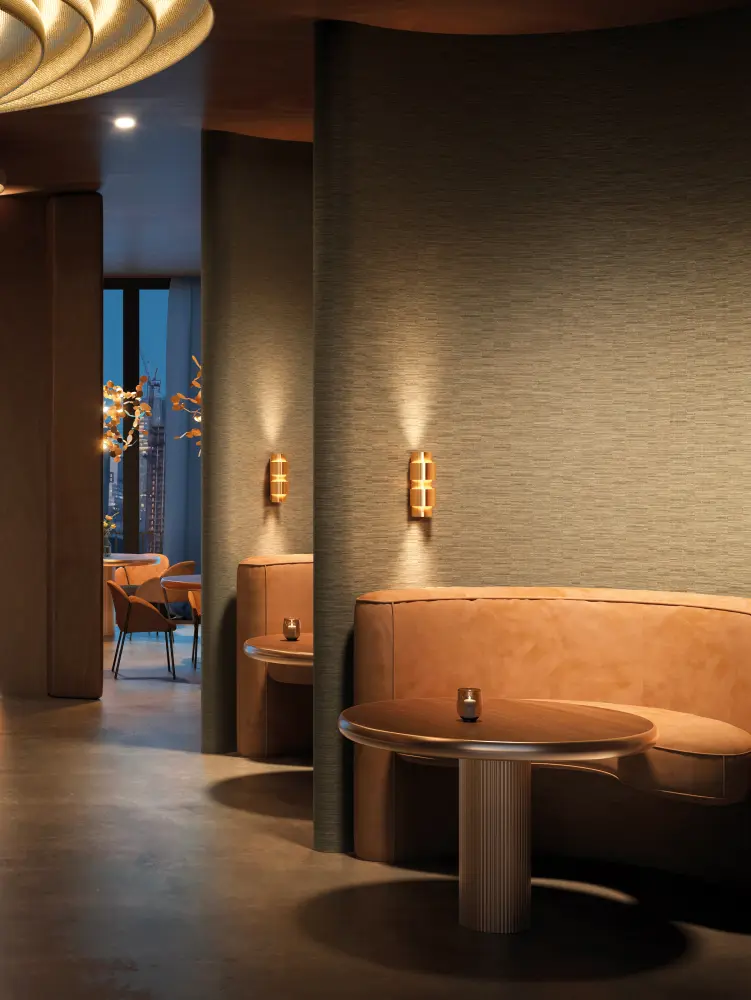 Vescom Viveo textile wallcovering with a jacquard woven texture and subtle irregular colour variation creating a lively surface with soft sheen, shown on curved interior walls in a warm hospitality lounge setting