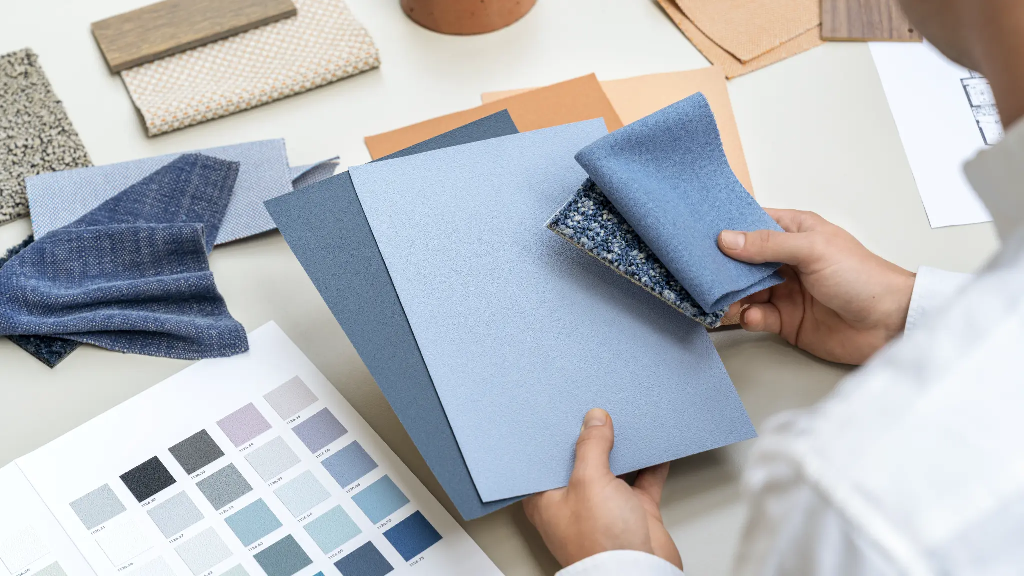 Vescom Colour Choice Blue Breeze vinyl wallcovering collage with a person holding samples and matching colour palette