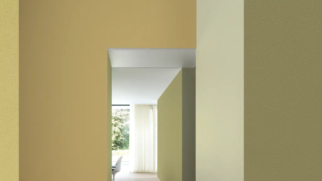 Vescom Colour Choice Mellow Ochre vinyl wallcovering in an interior with warm yellow tones and natural light
