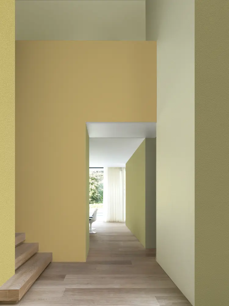 Vescom Colour Choice Mellow Ochre vinyl wallcovering in an interior with warm yellow tones and natural light