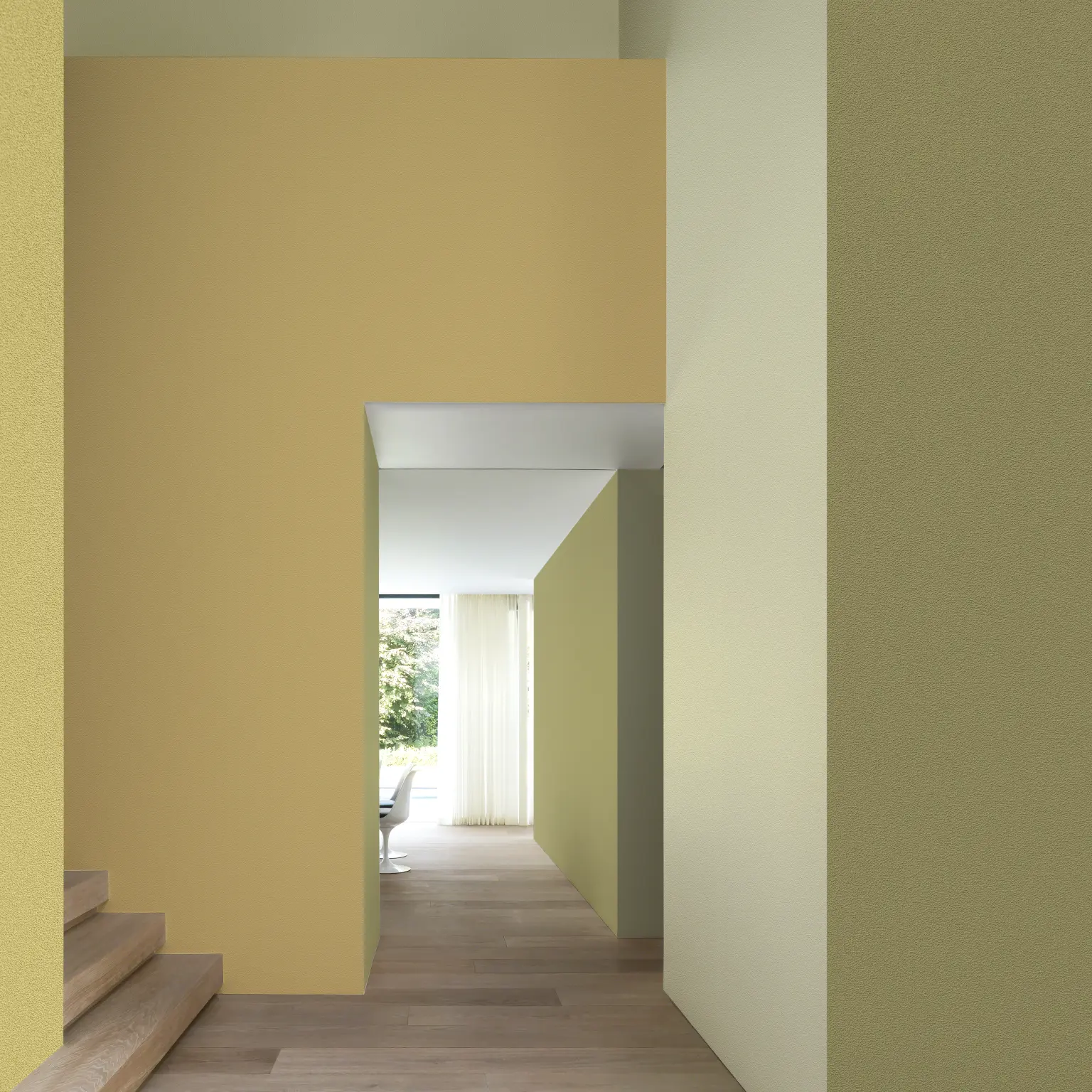 Vescom Colour Choice Mellow Ochre vinyl wallcovering in an interior with warm yellow tones and natural light