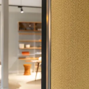 Interior featuring high-performance Vescom wallcovering with a structured herringbone stripe and a matte, layered look in a rich golden colour.