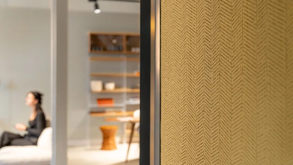 Interior featuring high-performance Vescom wallcovering with a structured herringbone stripe and a matte, layered look in a rich golden colour.