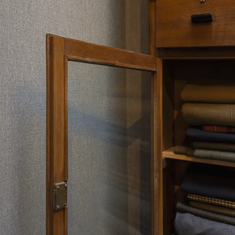 Vescom Harrison wallcovering in a moody interior, bringing the depth and warmth of woollen tailoring to the wall.