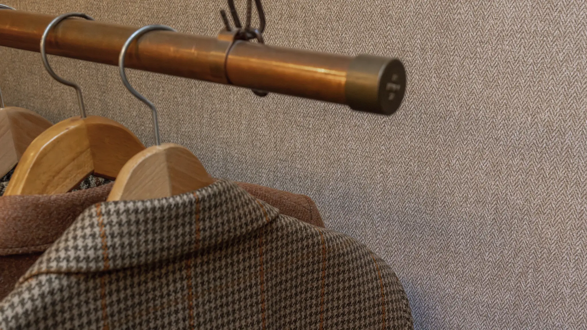 Vescom Harrison inspiration image with warm herringbone wallcovering samples and tailored material references.