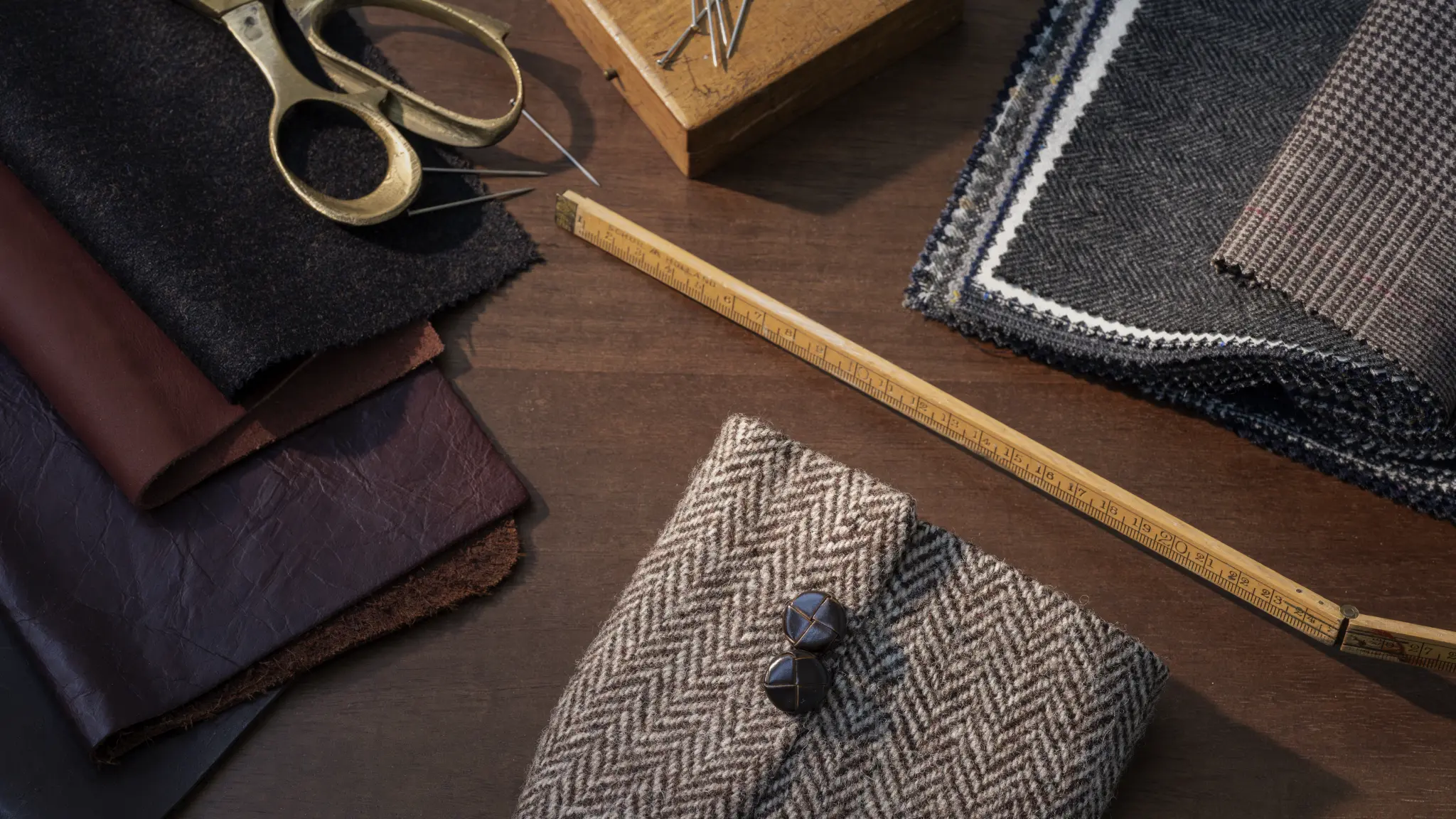 Vescom Harrison inspiration setting with dark suiting fabrics and herringbone textures for refined interiors.