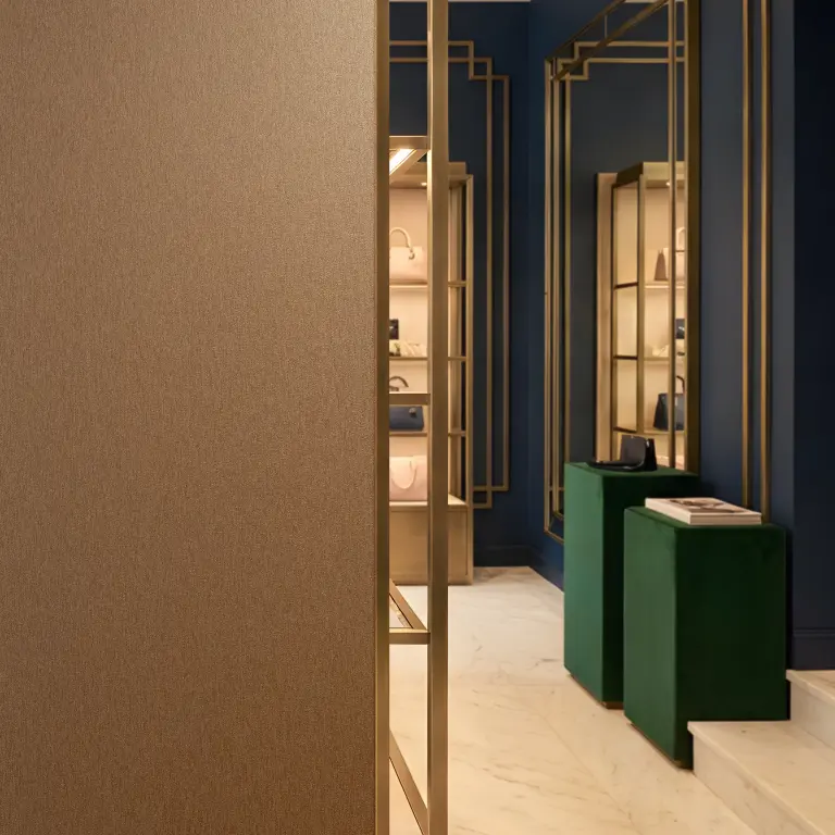 Vescom Stellar vinyl wallcovering adding a soft metallic sheen to a warm, atmospheric interior.