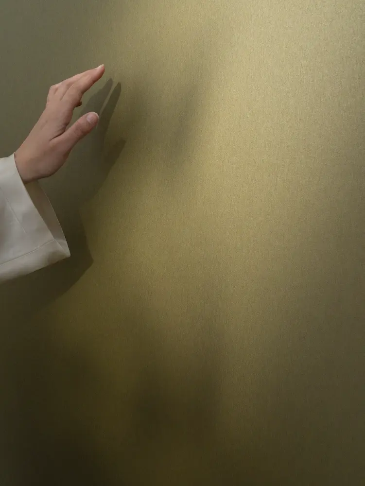 Vescom Stellar wallcovering with a brushed metallic finish and warm mineral character.