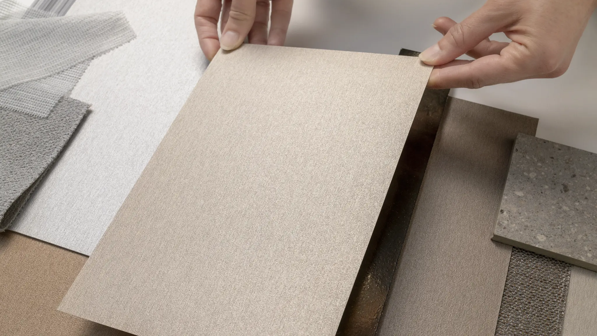 Vescom Stellar samples arranged by hand in a colour palette with blush, copper and mineral-toned wallcovering references.
