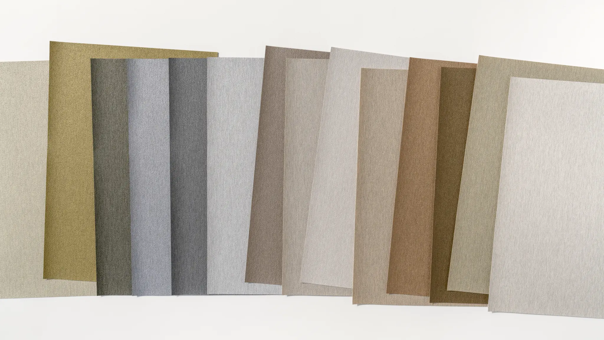 Vescom Stellar colour range showing recycled vinyl wallcovering samples in soft metallic and mineral tones.