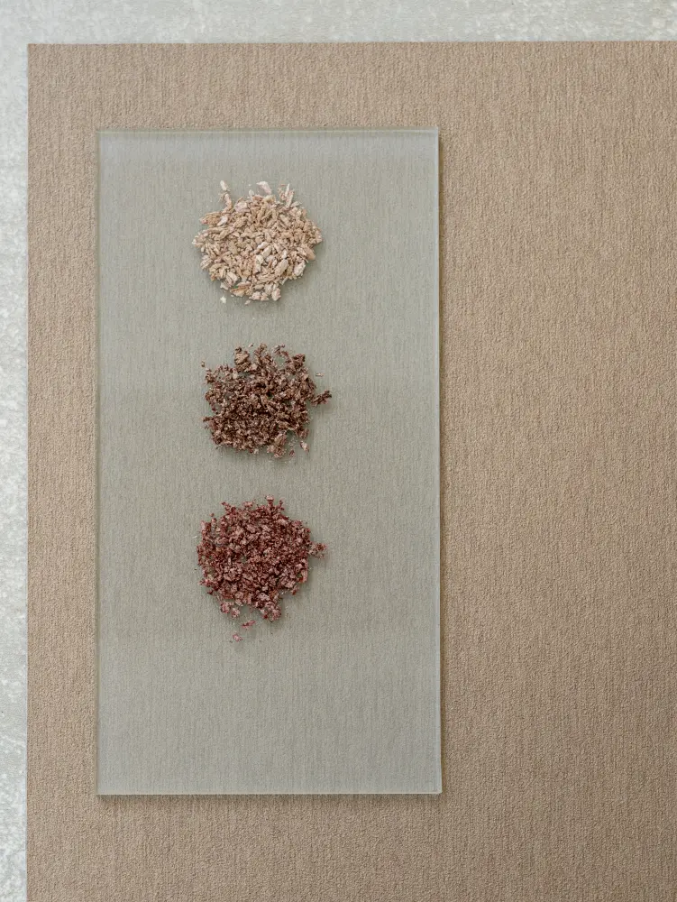 Colour and material study with small pigment samples, reflecting the mineral tones of Vescom Stellar.