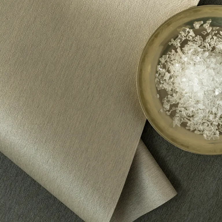 Vescom Stellar recycled vinyl wallcovering shown with plastic medical waste used to create recycled content.